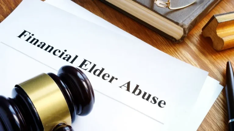 Document titled "Financial Elder Abuse" on wooden desk with judge's gavel, book, and pen.