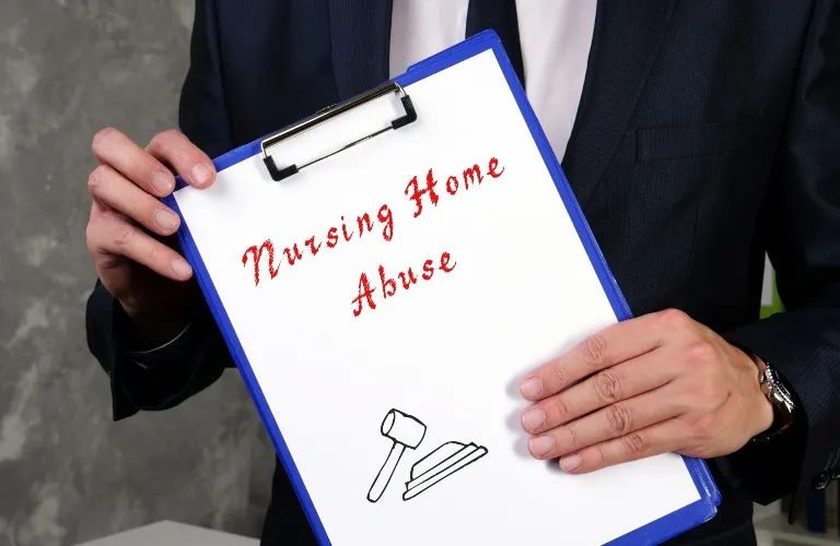 Person in dark suit holding blue clipboard with text "Nursing Home Abuse" and gavel illustration.