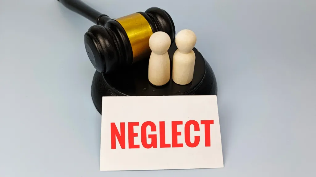Black and gold judge's gavel with two wooden figurines and a card reading "NEGLECT" in red letters.